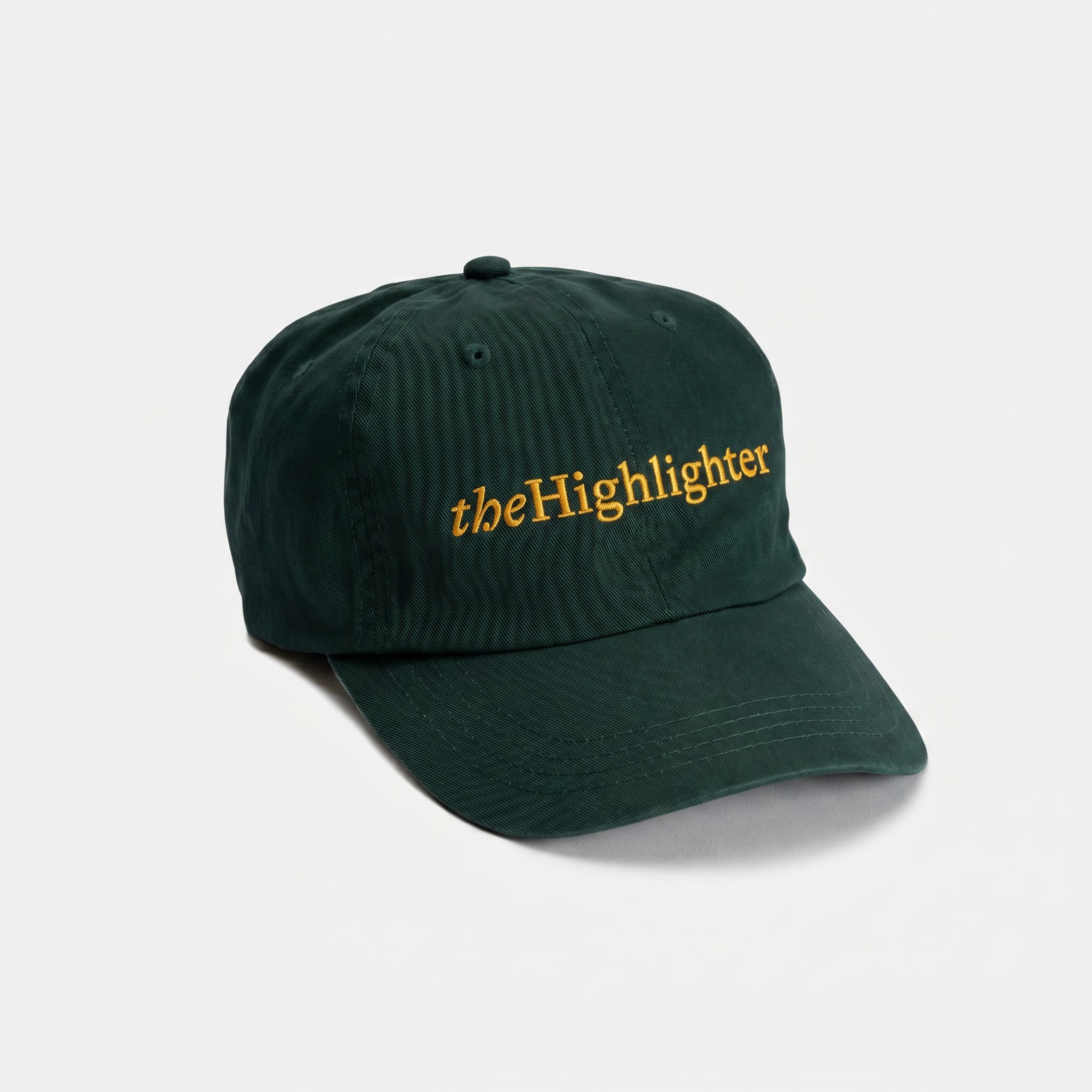 The Highlighter Grad Cap — forest green washed cotton with yellow embroidered wordmark